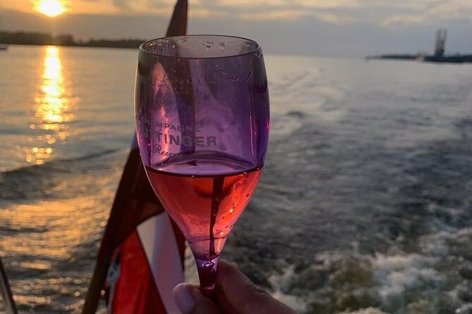 Riga: Evening or Sunset Boat Tour with Drink and Audio Guide - Through Riga’s canals and onto the river